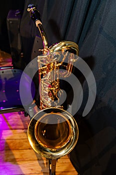 A gold colored saxophone is on display photo