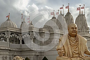 The gold colored statue of spiritual leader holiness pramukh swami maharaj front of Neasden temple