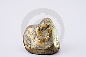 Gold-colored stones in natural shape on a white background with
