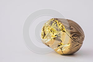 Gold-colored stones in natural shape on a white background with