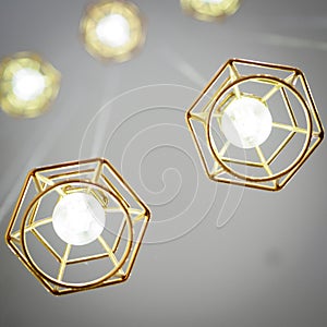 Gold coloured wire frame hanging lamps.