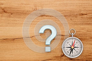 Gold compass on wooden board background. 3D illustration