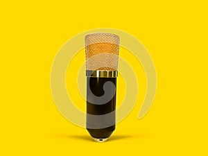 Gold condenser microphone isolated on yellow background
