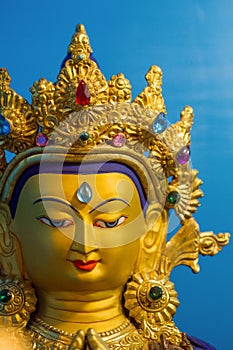 Gold covered statue of buddhist deity of compassion Chenrezig.