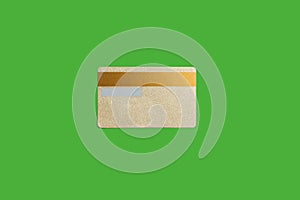 Gold credit card isolated on the green background