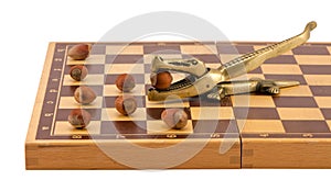 Gold crocodile nut crush tool chess board isolated