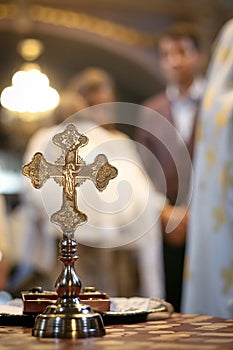 Gold cross for christening in the orthodox church. Church attributes