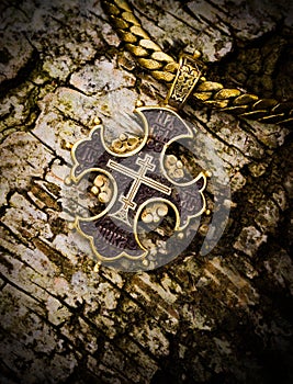 Gold cross on a tree bark christianity, smutty photo