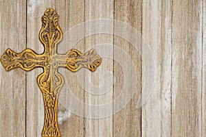 Gold cross on weathered wood