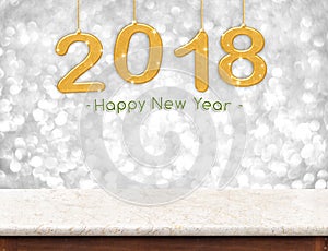 Gold 2018 3d rendering happy new year hanging over marble tabl