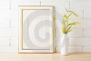 Gold decorated frame mockup with yellow green wild grass ears