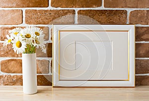 Gold decorated landscape frame mockup with daisy bouquet in vase