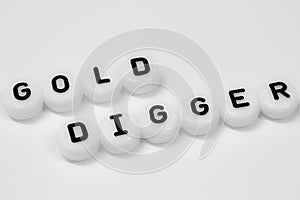 GOLD DIGGER written on white circles isolated on a white background