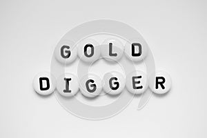 GOLD DIGGER written on white circles isolated on a white background