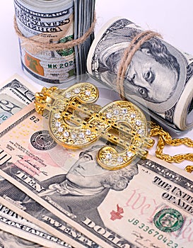 Gold Dollar Sign Necklace on a United States Dollars Banknotes