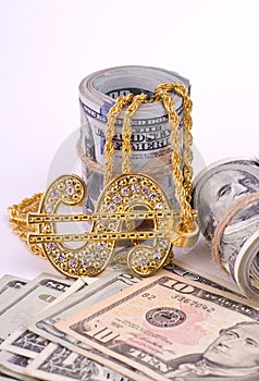 Gold Dollar Sign Necklace on a United States Dollars Banknotes