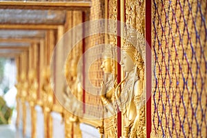 Gold door angel sculpture is a high relief art and is made of resin at the Golden Castle, Tha Sung Temple, Uthai Thani