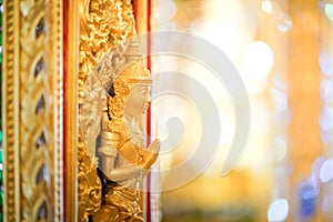 Gold door angel sculpture is a high relief art and is made of resin at the Golden Castle, Tha Sung Temple, Uthai Thani