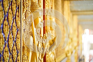 Gold door angel sculpture is a high relief art and is made of resin at the Golden Castle, Tha Sung Temple, Uthai Thani