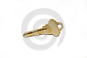 A gold door key isolated on a white background