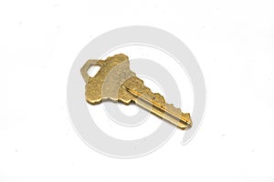 A gold door key isolated on a white background