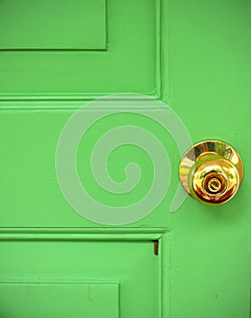 Gold door knob on green