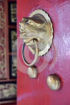 Gold doorknocker at chinese temple