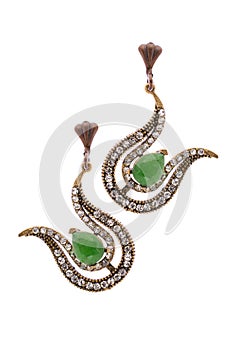 Gold earrings in the form of harps  inlaid with  gemstones on a white background