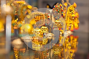 Gold earrings with reflection in jewelery shop