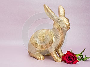 gold Easter bunny rabbit on pink background