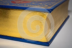 Gold edge of closed old vintage book with blue cover