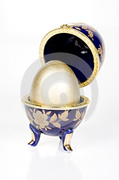 Gold egg in a glass eggcup