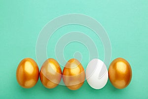 Gold egg with white on mint background