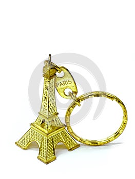 Gold Eiffel tower key chain isolate background