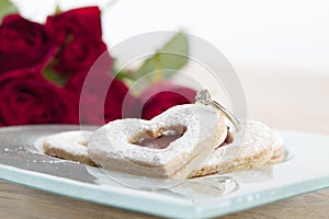 Gold engagement ring and shortbread hearts