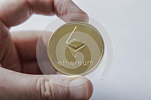 A Large Etherium Token in hand