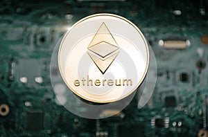 Gold etherum coin, on background of computer motherboard