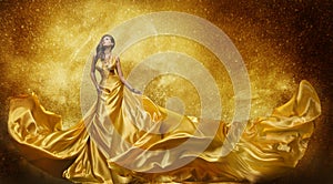 Gold Fashion Model Dress, Woman Golden Silk Gown Flowing Fabric photo