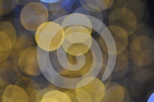 Gold festive glitter background with defocused lights.Abstract gold circular bokeh background of christmas light gold