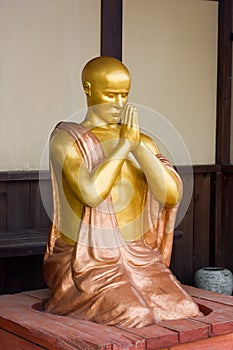 Gold figure of the praying monk