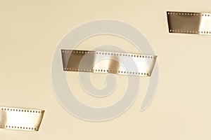 Gold film strips on beige background. Horizontal media theme poster, greeting cards, headers, website and app