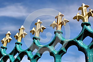 Gold fleur de lis on blue iron railings