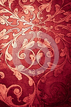 Gold flourish design. Red decorative background.