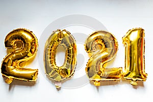 Gold foil balloons numeral 2021 on white background. Happy New year 2021 celebration