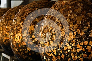 Gold foils pasted on the surface of Luuk Nimit round stones for