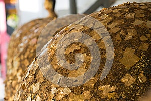 Gold foils pasted on the surface of Luuk Nimit round stones for