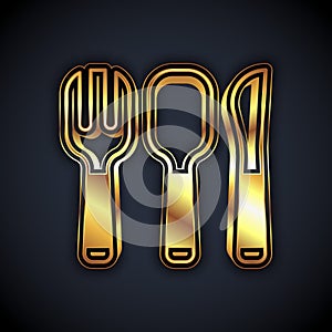 Gold Fork, spoon and knife icon isolated on black background. Cooking utensil. Cutlery sign. Vector