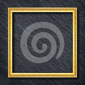 A gold frame on Dark grey black slate background or texture