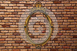 Gold frame on old brick wall