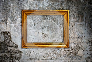 Gold frame on a old wall